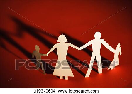 Picture - Paper cutout family of four standing holding hands. Fotosearch