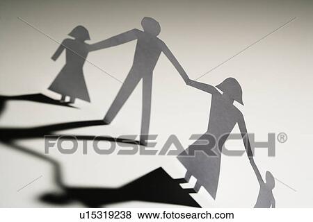 Paper cutout family of four standing holding hands. View Large Photo Image Stock Photo - Paper cutout family of four standing holding hands.. Fotosearch