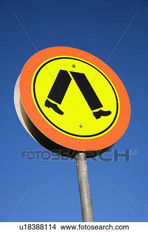 Picture - Pedestrian crosswalk sign with blue sky in Australia.. Fotosearch