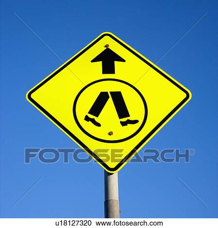 Stock Image - Pedestrian crosswalk sign with blue sky in Australia. Fotosearch