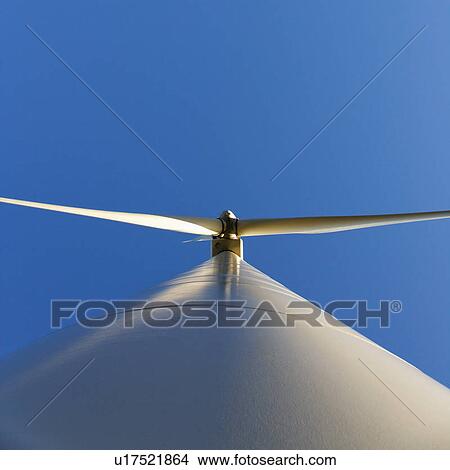 Perspective shot of wind turbine against blue sky. View Large Photo Image Picture - Perspective shot of wind turbine against blue sky.. Fotosearch