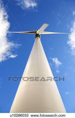 Perspective shot of wind turbine against blue sky View Large Photo Image Stock Image - Perspective shot of wind turbine against blue sky. Fotosearch