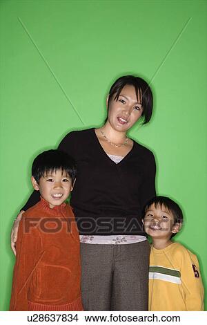 Portrait of Asian mother with two young boys smiling. View Large Photo Image Picture - Portrait of Asian mother with two young boys smiling.. Fotosearch