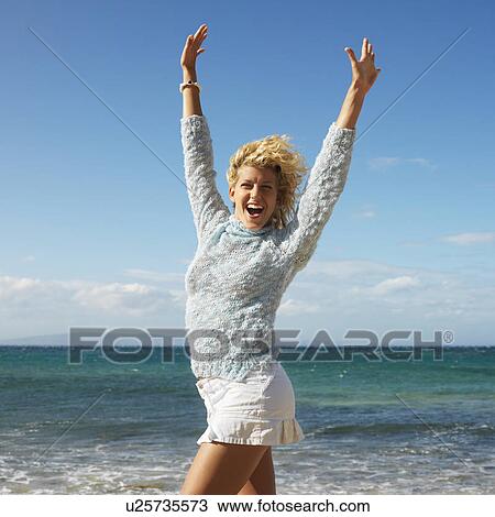 Portrait of attractive young blond woman smiling with arms raised in air on Maui, Hawaii beach. View Large Photo Image Stock Image - Portrait of attractive young blond woman smiling with arms raised in air on Maui, Hawaii beach.. Fotosearch