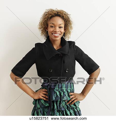 Stock Image - Portrait of pretty young woman smiling.. Fotosearch