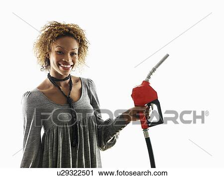 Portrait of pretty young woman smiling holding gas pump nozzle on white background. View Large Photo Image Stock Image - Portrait of pretty young woman smiling holding gas pump nozzle on white background.. Fotosearch