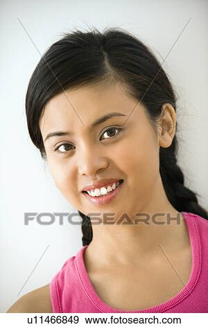 Stock Photo - Portrait of smiling young Asian woman.. Fotosearch