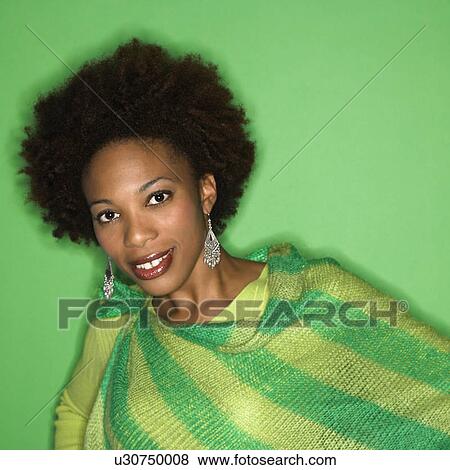 Portrait of woman with afro wearing green striped shawl on green background smiling. View Large Photo Image Stock Photo - Portrait of woman with afro wearing green striped shawl on green background smiling.. Fotosearch