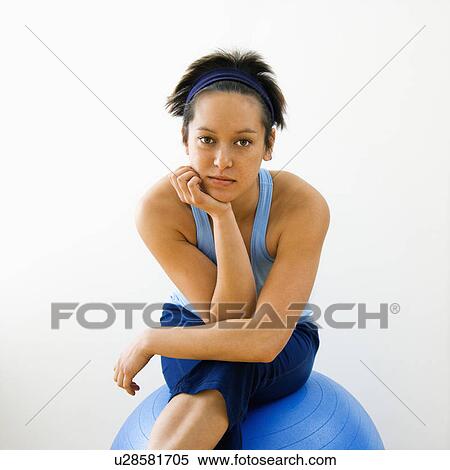 Portrait of young woman sitting on fitness balance ball View Large Photo Image Stock Photography - Portrait of young woman sitting on fitness balance ball. Fotosearch