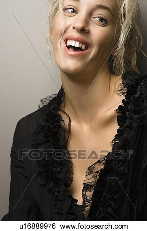 Stock Photograph - Pretty woman smiling and looking to side. Fotosearch