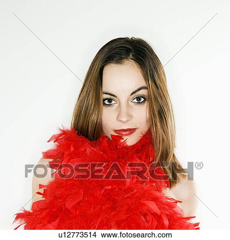 Picture - Pretty woman with red feather boa around body looking at viewer. Fotosearch