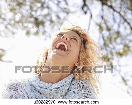 Pretty young blond woman in Maui, Hawaii leaning head back and laughing. View Large Photo Image Stock Image - Pretty young blond woman in Maui, Hawaii leaning head back and laughing.. Fotosearch