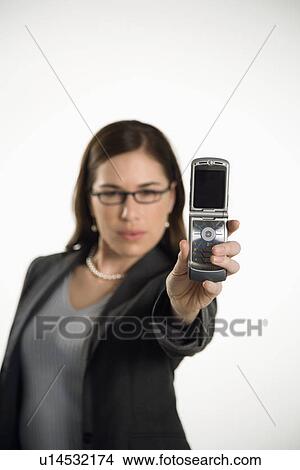 Picture - Professional business woman taking picture of self with camera phone. Fotosearch