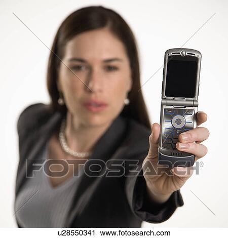 Stock Image - Professional business woman taking picture of self with camera phone. Fotosearch