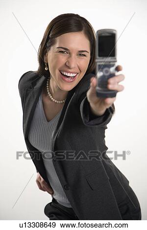 Professional business woman taking picture of self with camera phone and smiling View Large Photo Image Stock Photo - Professional business woman taking picture of self with camera phone and smiling. Fotosearch