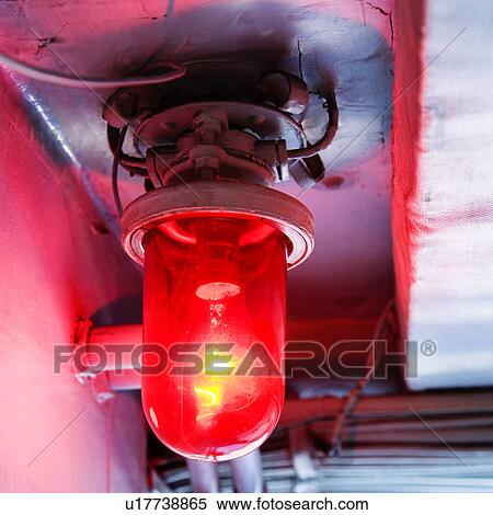 Red light bulb glowing from rustic fixture View Large Photo Image Stock Photography - Red light bulb glowing from rustic fixture. Fotosearch