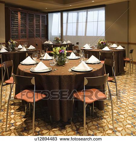 Stock Image - Restaurant interior with table setting and chairs. Fotosearch