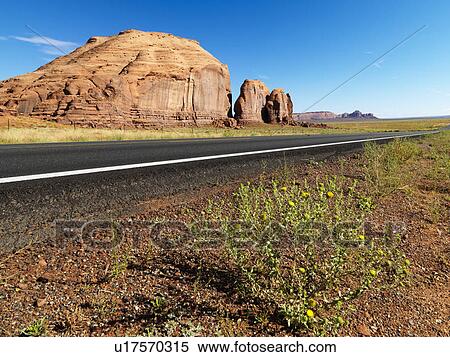 Road in scenic desert landscape with butte land formation. View Large Photo Image Stock Photography - Road in scenic desert landscape with butte land formation.. Fotosearch