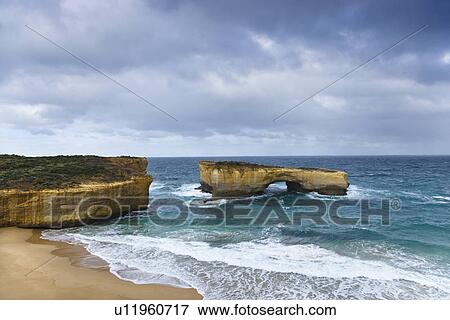 Rock formation in arch shape as seen from Great Ocean Road in Australia View Large Photo Image Stock Photo - Rock formation in arch shape as seen from Great Ocean Road in Australia. Fotosearch