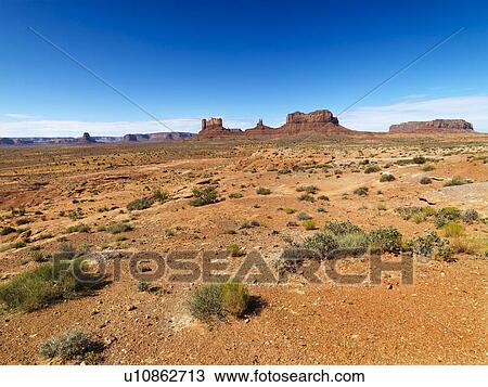 Stock Image - Scenic desert landforms in distance of landscape.. Fotosearch