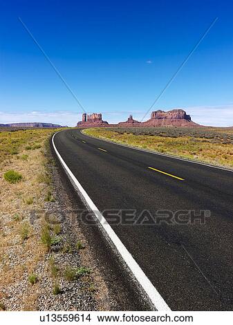 Scenic desert road with mountain land formations. View Large Photo Image Picture - Scenic desert road with mountain land formations.. Fotosearch