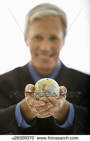 Selective focus of Caucasian middle aged businessman smiling and holding globe towards viewer. View Large Photo Image Stock Image - Selective focus of Caucasian middle aged businessman smiling and holding globe towards viewer.. Fotosearch