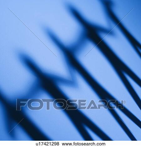 Shadow of cutout paper men standing holding hands View Large Photo Image Stock Photo - Shadow of cutout paper men standing holding hands. Fotosearch