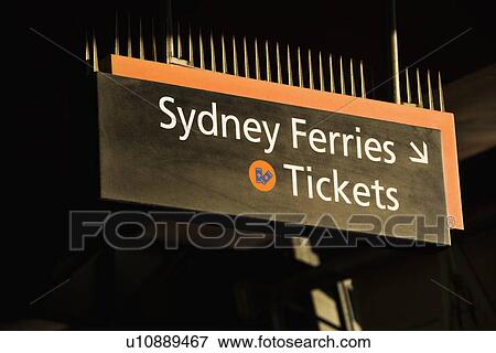 Stock Photo - Sign pointing to ticket booth for ferryboats in Sydney, Australia. Fotosearch