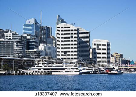 Stock Photo - Skyscraper and waterway in Darling Harbour in Sydney, Australia.. Fotosearch