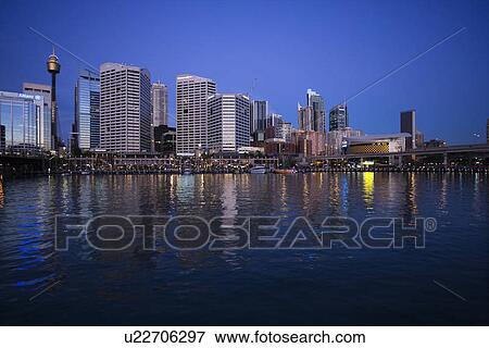 Stock Photo - Skyscrapers and Darling Harbour at dusk in Sydney, Australia. Fotosearch