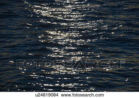 Sunlight hitting waves in water View Large Photo Image Picture - Sunlight hitting waves in water. Fotosearch