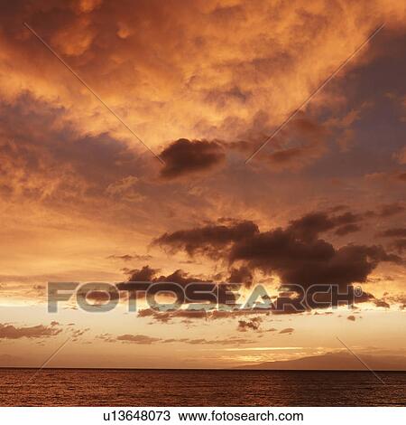 Stock Image - Sunset over the Pacific near Maui, Hawaii. Fotosearch