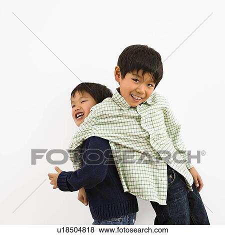 Two young Asian brothers playing and laughing. View Large Photo Image Stock Photo - Two young Asian brothers playing and laughing.. Fotosearch