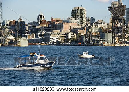 Water taxi boat in Sydney, Australia with city buildings. View Large Photo Image Stock Photograph - Water taxi boat in Sydney, Australia with city buildings.. Fotosearch