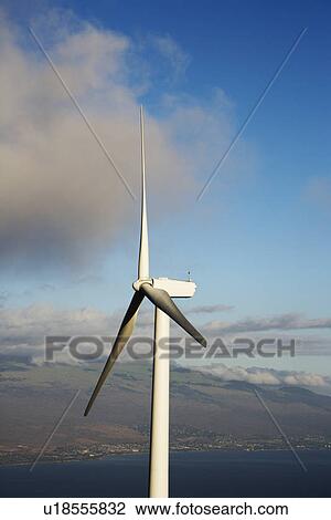 Stock Image - Wind turbine with Hawaiian landscape in background.. Fotosearch