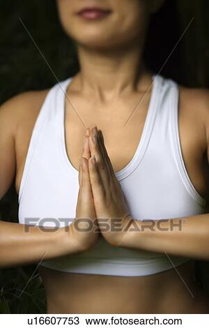 Woman in fitness attire standing in yoga position View Large Photo Image Stock Image - Woman in fitness attire standing in yoga position. Fotosearch