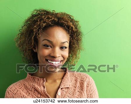 Stock Image - Woman on green background. Fotosearch