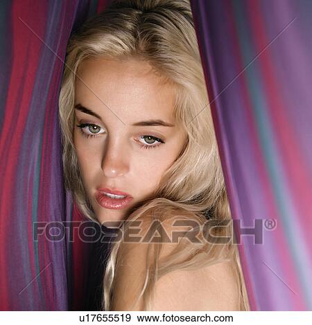 Woman standing between colorful fabric View Large Photo Image Stock Photo - Woman standing between colorful fabric. Fotosearch