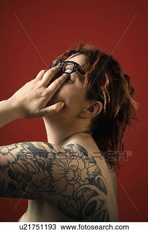 Woman with tattoos rubbing her eyes View Large Photo Image Stock Image - Woman with tattoos rubbing her eyes. Fotosearch