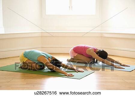 Women on yoga mats doing child's pose View Large Photo Image Stock Photograph - Women on yoga mats doing child's pose. Fotosearch