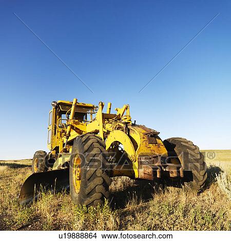 Yellow tractor in field. View Large Photo Image Picture - Yellow tractor in field. . Fotosearch