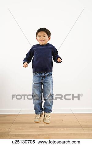 Young boy jumping and smiling View Large Photo Image Stock Photography - Young boy jumping and smiling. Fotosearch