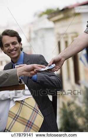 Businessmen at taverna paying bill View Large Photo Image Stock Image - Businessmen at taverna paying bill. Fotosearch