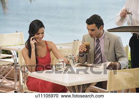 Couple at seaside cafe table View Large Photo Image Stock Image - Couple at seaside cafe table. Fotosearch