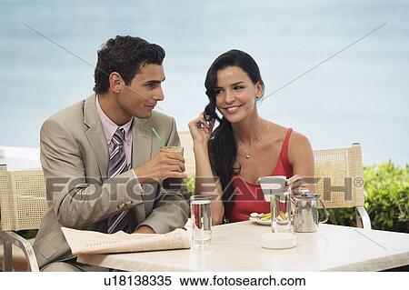 Stock Photography - Couple at seaside cafe table. Fotosearch