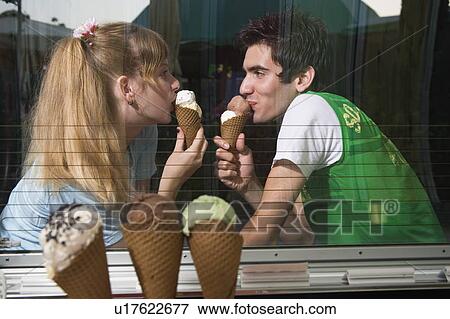 Teenage couple eating ice cream View Large Photo Image Stock Photo - Teenage couple eating ice cream. Fotosearch