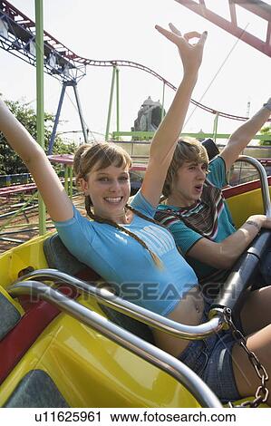 Teenage couple on amusement park ride View Large Photo Image Stock Image - Teenage couple on amusement park ride. Fotosearch