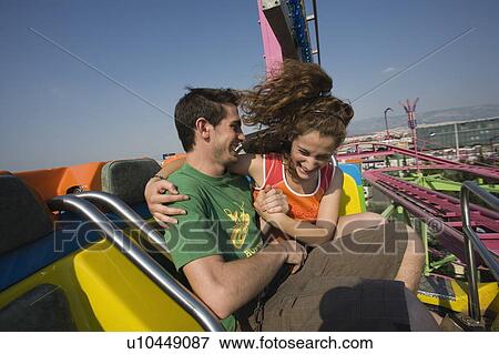 Stock Photo - Teenage couple on amusement park ride. Fotosearch