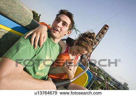 Stock Photo - Teenage couple on amusement park ride. Fotosearch