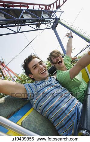 Teenage couple on amusement park ride View Large Photo Image Stock Photograph - Teenage couple on amusement park ride. Fotosearch
